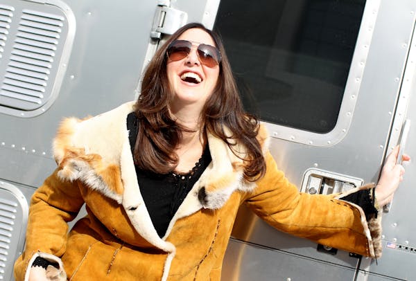 Claudia Lacy exits Jon Charles' mobile Hairstream trailer after getting her hair "blown out" in her friend's driveway in Wayzata