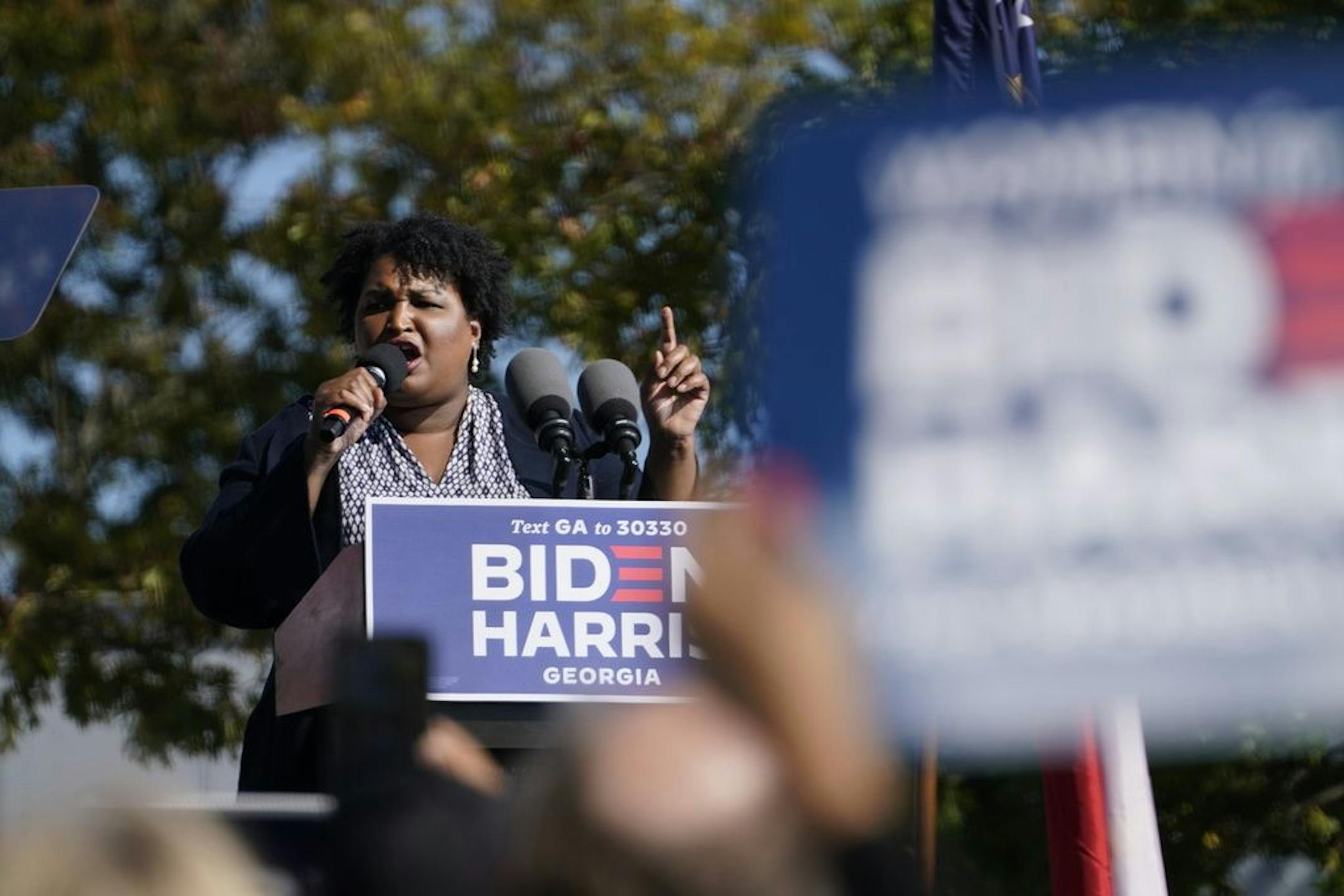 In this Nov. 2, 2020, photo, Stacey Abrams speaks to supporters as they wait for former President Barack Obama to arrive and speak at a rally as he campaigns for Democratic presidential candidate former Vice President Joe Biden, at Turner Field in Atlanta.