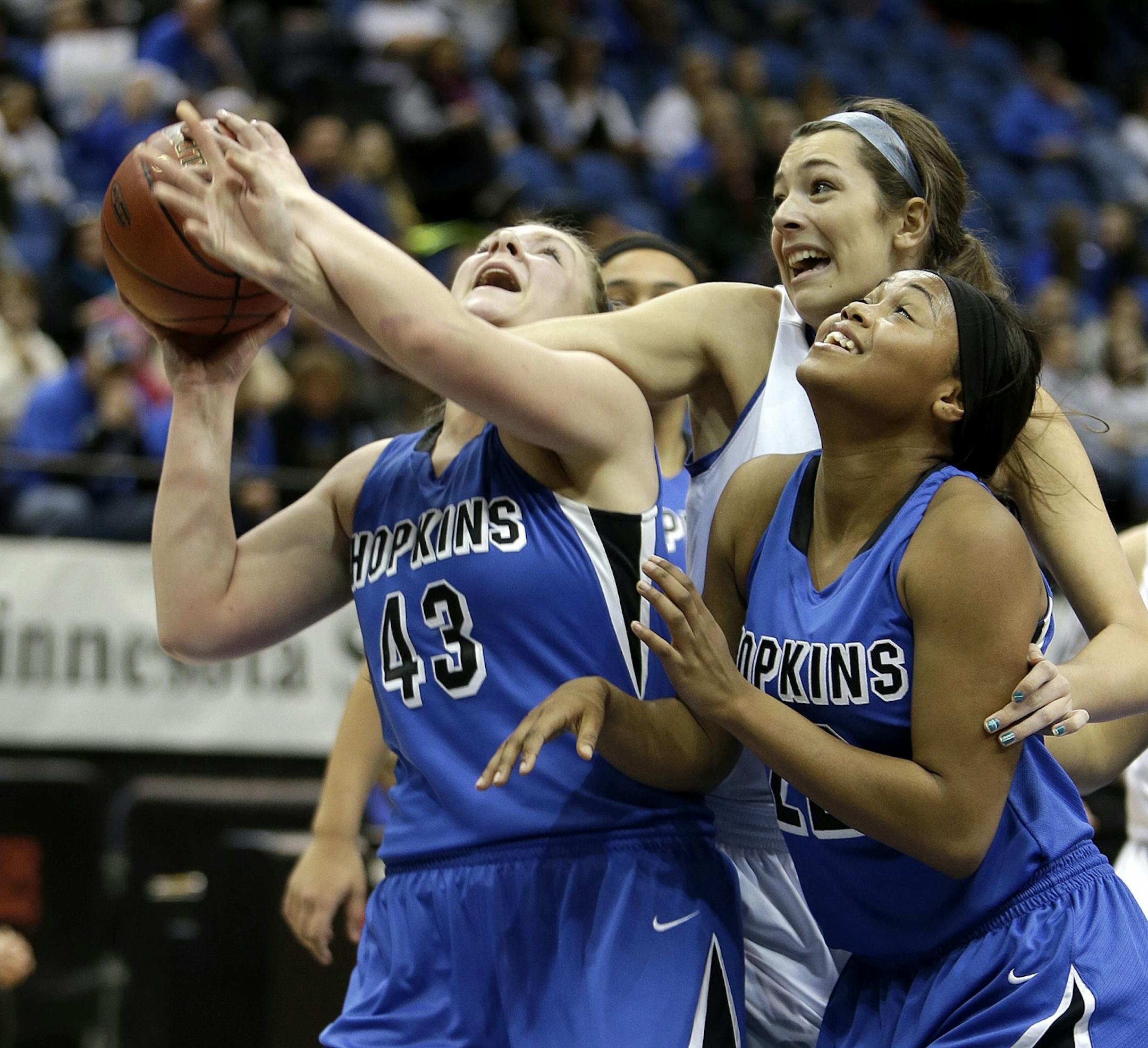 Hopkins Molly O'Toole, TT Starks and St. Michael-Albertville's Bre Grube battled for possession under the basket during the first period in girls' basketball quarterfinals at Target Center, Wednesday, March 13, 2013 in Minneapolis, MN.