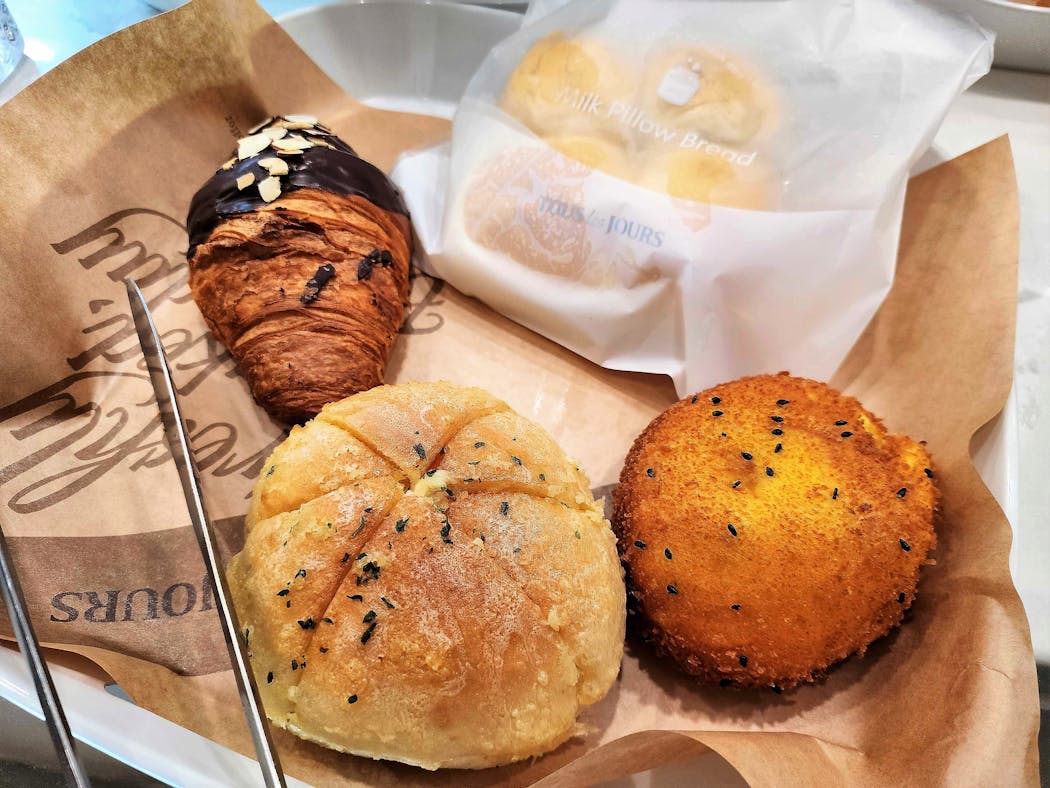A chocolate croissant, garlic cream cheese bread and curry croquette at Tous les Jours.