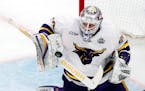 Minnesota State's Dryden McKay blocks a shot during the second period of an NCAA men's Frozen Four semifinal hockey game against Minnesota, Thursday, 