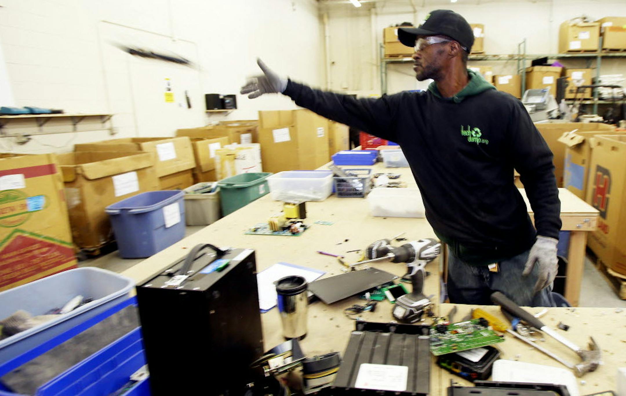 Ben Johnson of expanding TechDump.org of Golden Valley dissassembled old electronic adding machines in February. Tech Dump, which hires former criminal offenders, will refurbish and recycling more than 4 million pounds of consumer electronics this year.