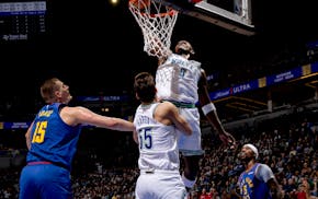 The Timberwolves' Anthony Edwards dunks the ball against the Nuggets in the first quarter Tuesday at Target Center.