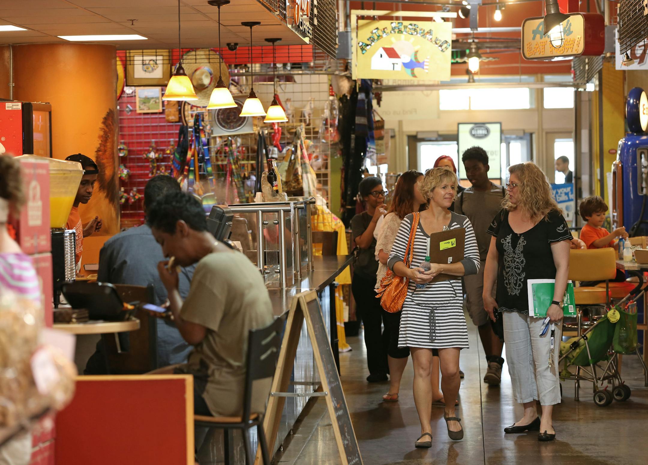 People milled through the Midtown Global Market during the lunch hour on 6/26/13, which Mayor Rybak touts as one of his biggest achievements. The market was conceptualized 10 years ago this summer. The market has had its share of problems -- tenant turnover, squabbling among business owners -- but it's going strong and has significantly reduced crime in the Lake/Chicago area.] Bruce Bisping/Star Tribune bbisping@startribune.com