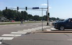 A pedestrian crosses at the intersection of University Avenue and Osborne Road, near where a man was struck by a vehicle and killed in March.