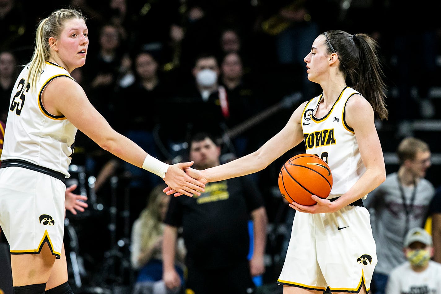 Iowa guard Caitlin Clark, right, gets a high-five from center Monika Czinano during Wednesday's game against the Gophers.