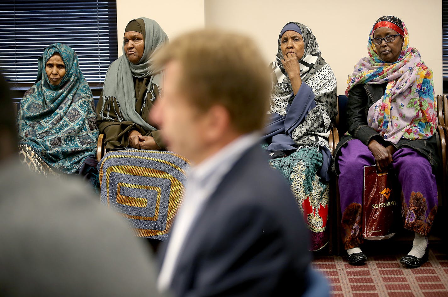 Residents of Riverside Plaza listened on Monday at City Hall as owner George Sherman, foreground, discussed changes for the complex.