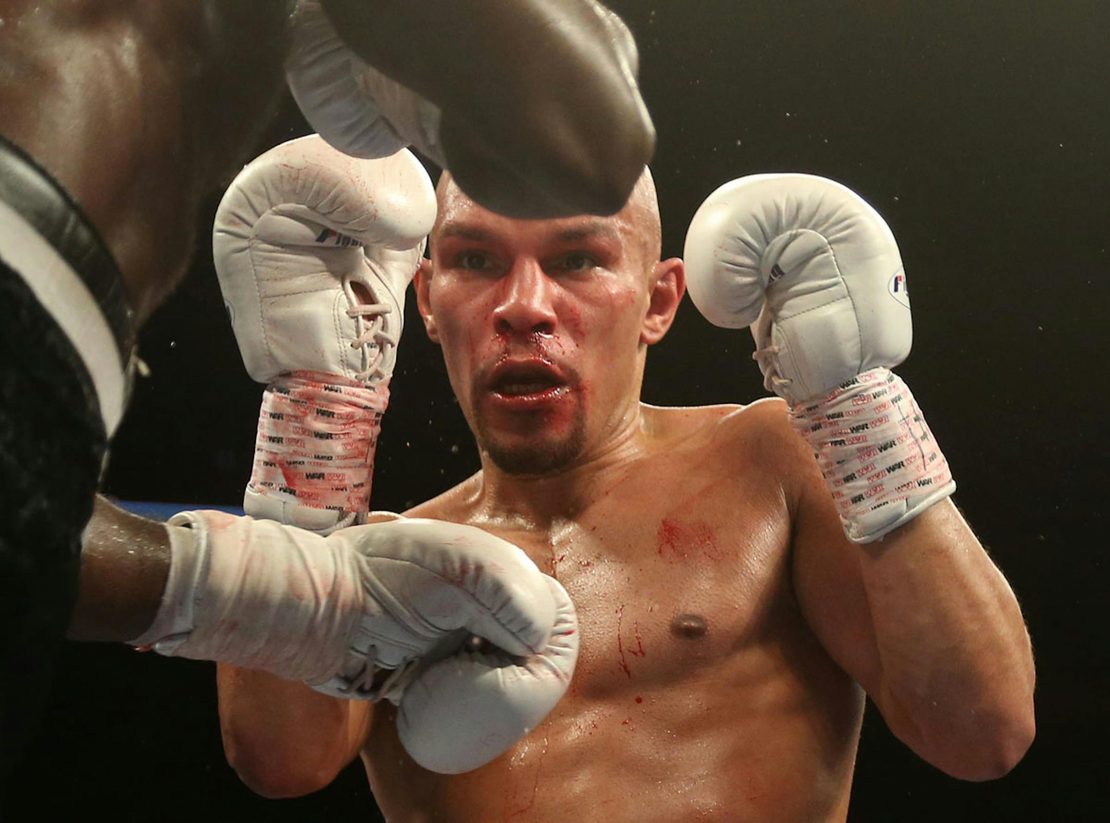 USBA Middleweight Champion Caleb Truax, of Osseo, Minnesota watched the hands of Ossie Duran aka - The Ghanaian Gladiator during a semi final fight at Target Center in Minneapolis Friday, January 3, 2014. The bout ended in a tie 95-95. ] (KYNDELL HARKNESS/STAR TRIBUNE) kyndell.harkness@startribune.com