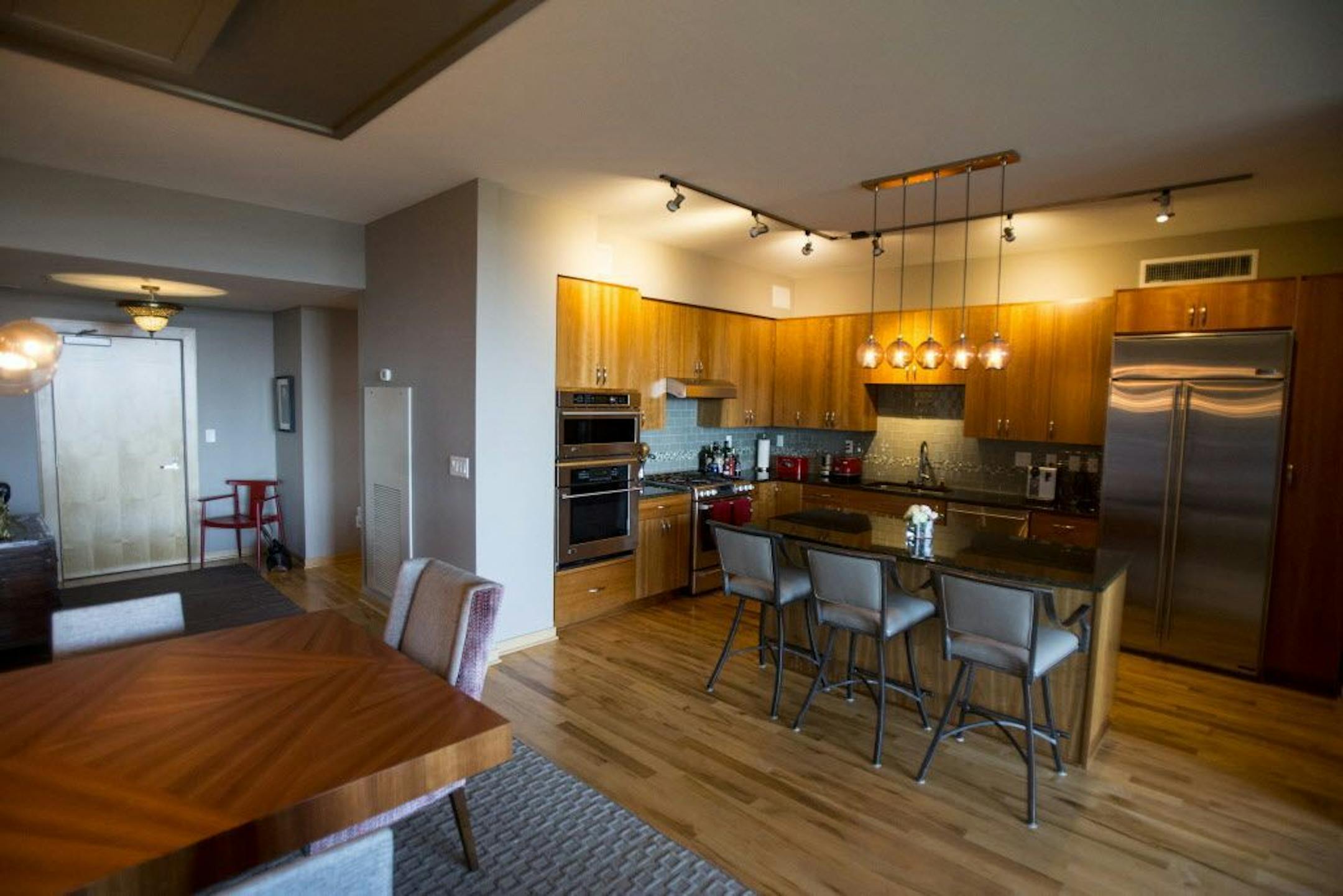 The Laws kept the existing cherry veneer kitchen cabinets and quartz counters, but updated the lighting and replaced some appliances.