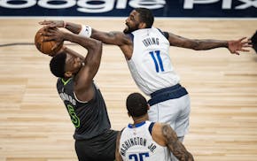 Dallas Mavericks guard Kyrie Irving (11) pressured Minnesota Timberwolves guard Anthony Edwards (5) in the first quarter Thursday. The Minnesota Ti