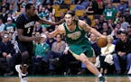 Boston Celtics center Kelly Olynyk (41) drives to the basket against Minnesota Timberwolves forward Gorgui Dieng (5) during the first quarter of an NB