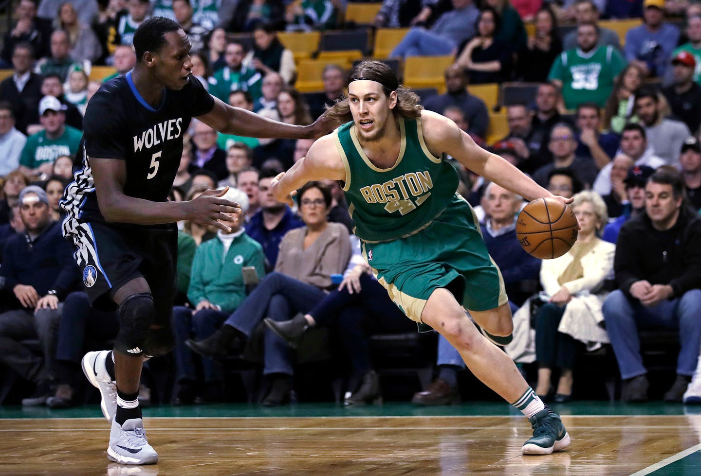 Boston Celtics center Kelly Olynyk (41) drives to the basket against Minnesota Timberwolves forward Gorgui Dieng (5) during the first quarter of an NBA game in Boston, Wednesday, March 15, 2017. (AP Photo/Charles Krupa)