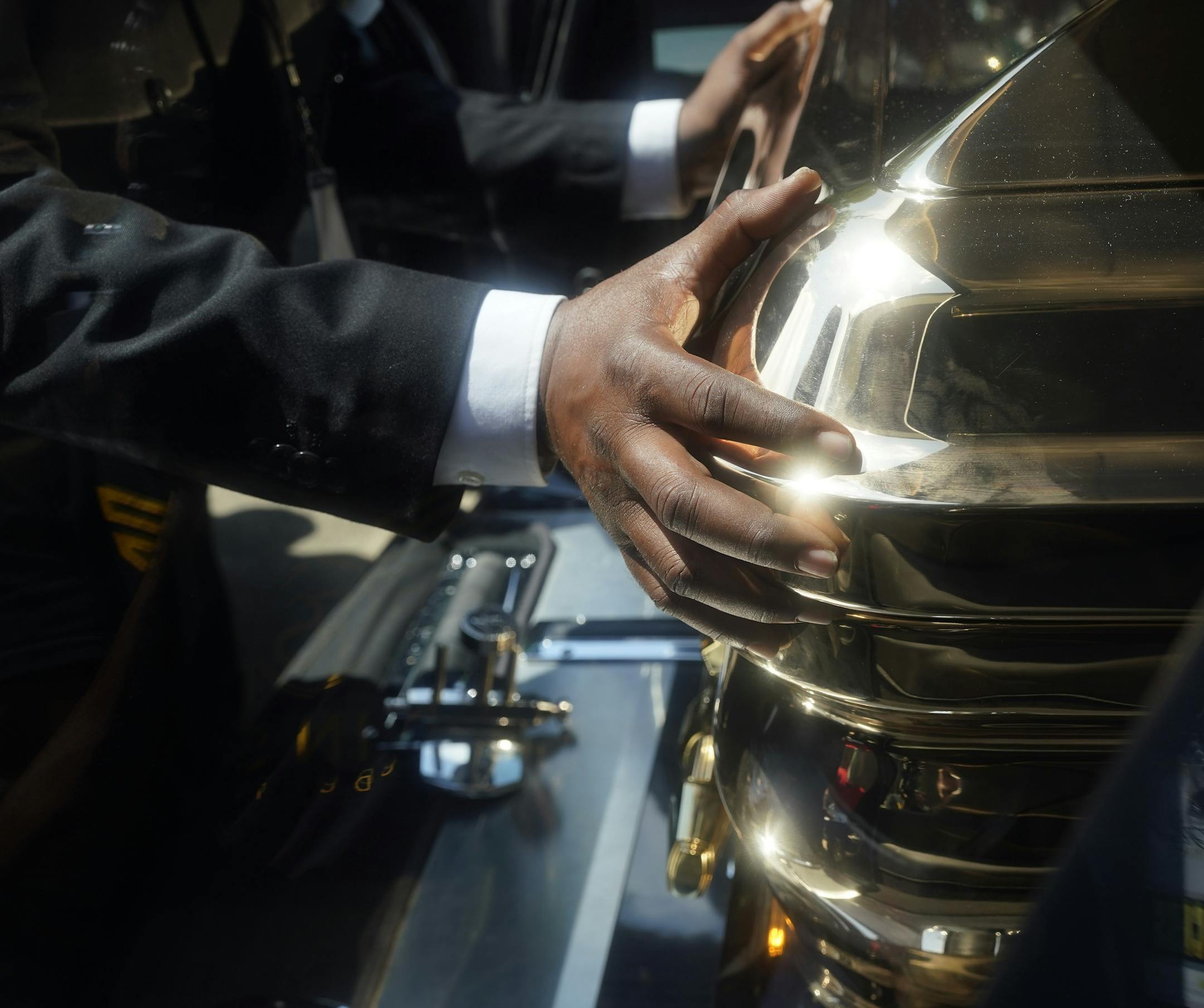 The hands of funeral home staff move the casket of George Floyd into a hearse after the funeral service for Floyd at The Fountain of Praise church Tuesday, June 9, 2020, in Houston. (AP Photo/David J. Phillip, Pool)
