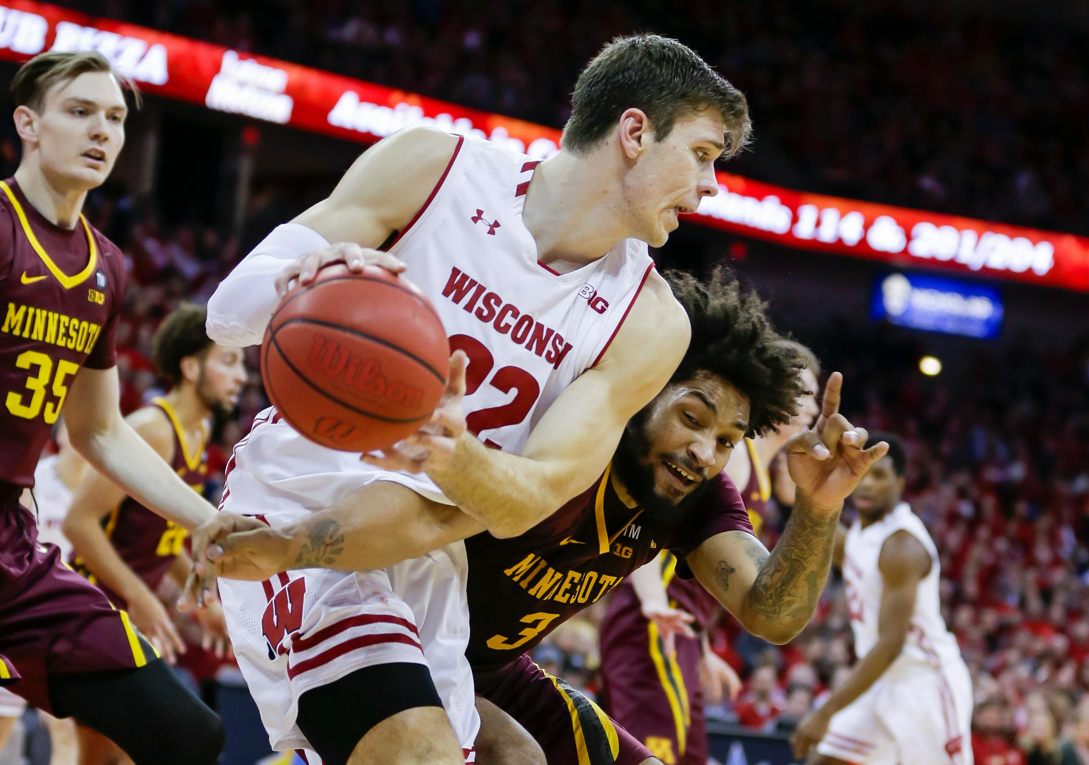 Minnesota's Jordan Murphy (3) reaches in on Wisconsin's Ethan Happ (22) during the second half on Jan. 3 in Madison