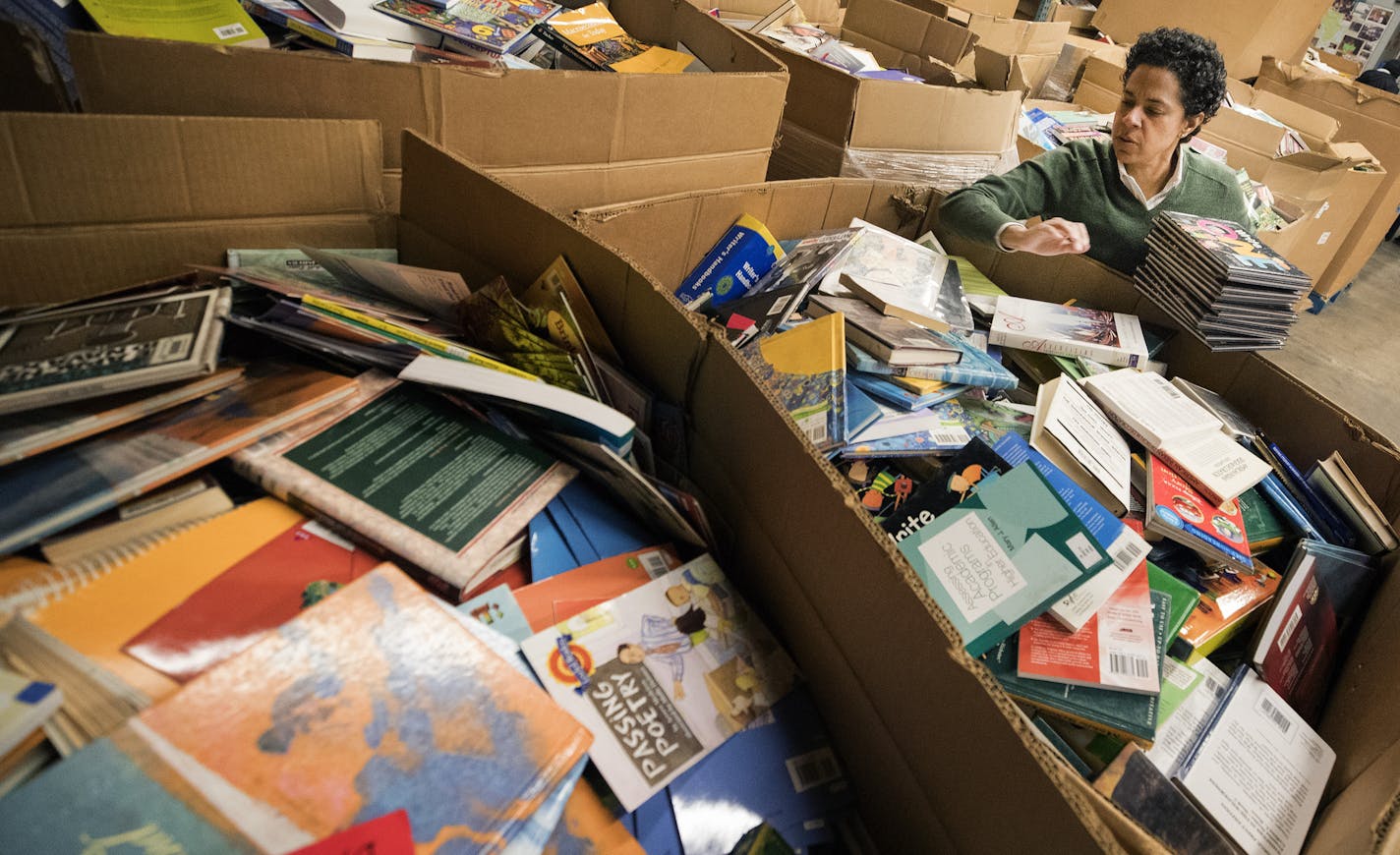 Marla Butler of Plymouth sorted books at St. Paul-based charity Books for Africa, which Tom Warth started 30 years ago and turned into one of the state's most well-known charities.