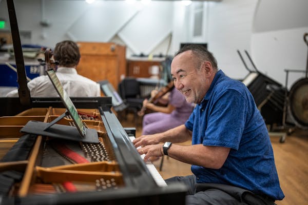 Jon Kimura Parker plays piano during rehearsals with members of the chamber orchestra at Orchestra Hall on Wednesday. 