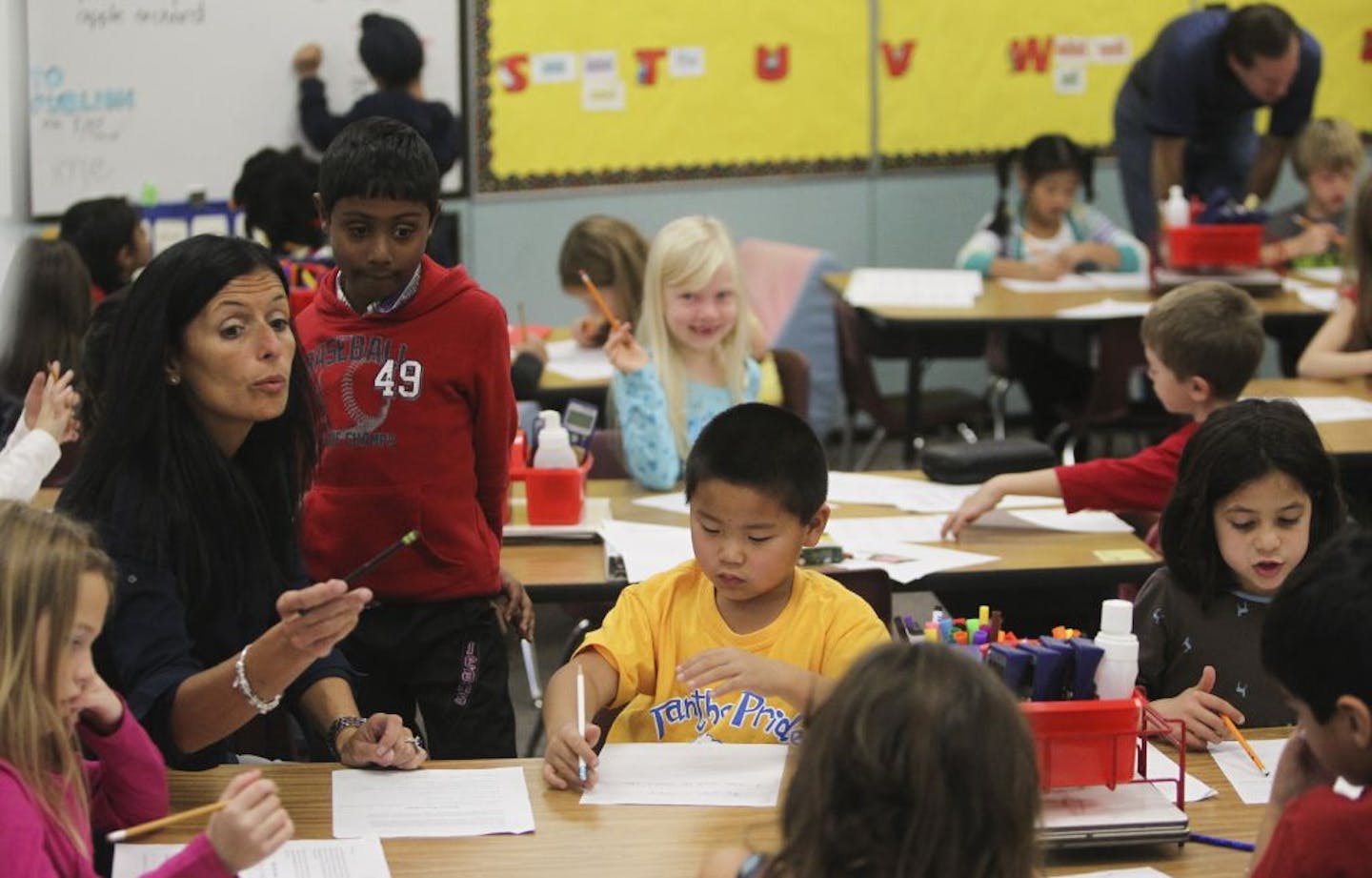 With growth on one side of the Plymouth school district, classrooms are quickly filling up like this one at Plymouth Creek Elementary School in Plymouth, MN, Tuesday, Oct. 16, 2012. Thirty six third graders now use the room along with two teachers and the growth does not appear to be waning. Here, teacher Lisa Barnholdt works with students on an in-class assignment.