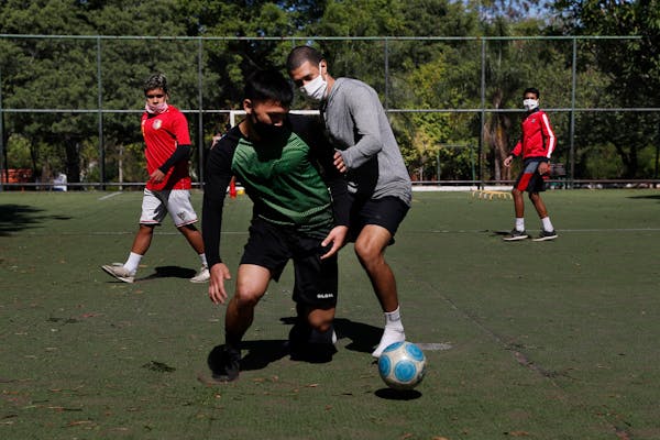 Youths wore masks to protect themselves from the spread of coronavirus played soccer in Asuncion, Paraguay. Two competing Minnesota youth soccer assoc