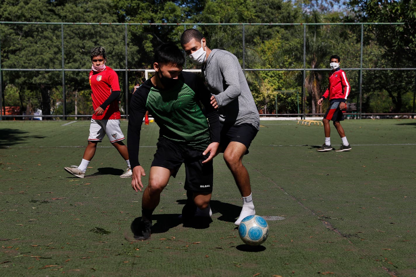 Youths wore masks to protect themselves from the spread of coronavirus played soccer in Asuncion, Paraguay. Two competing Minnesota youth soccer associations have banded together to propose a plan — including appropriate safety protocols — that they hope will provide a path out of the coronavirus-induced idling of soccer throughout the state.