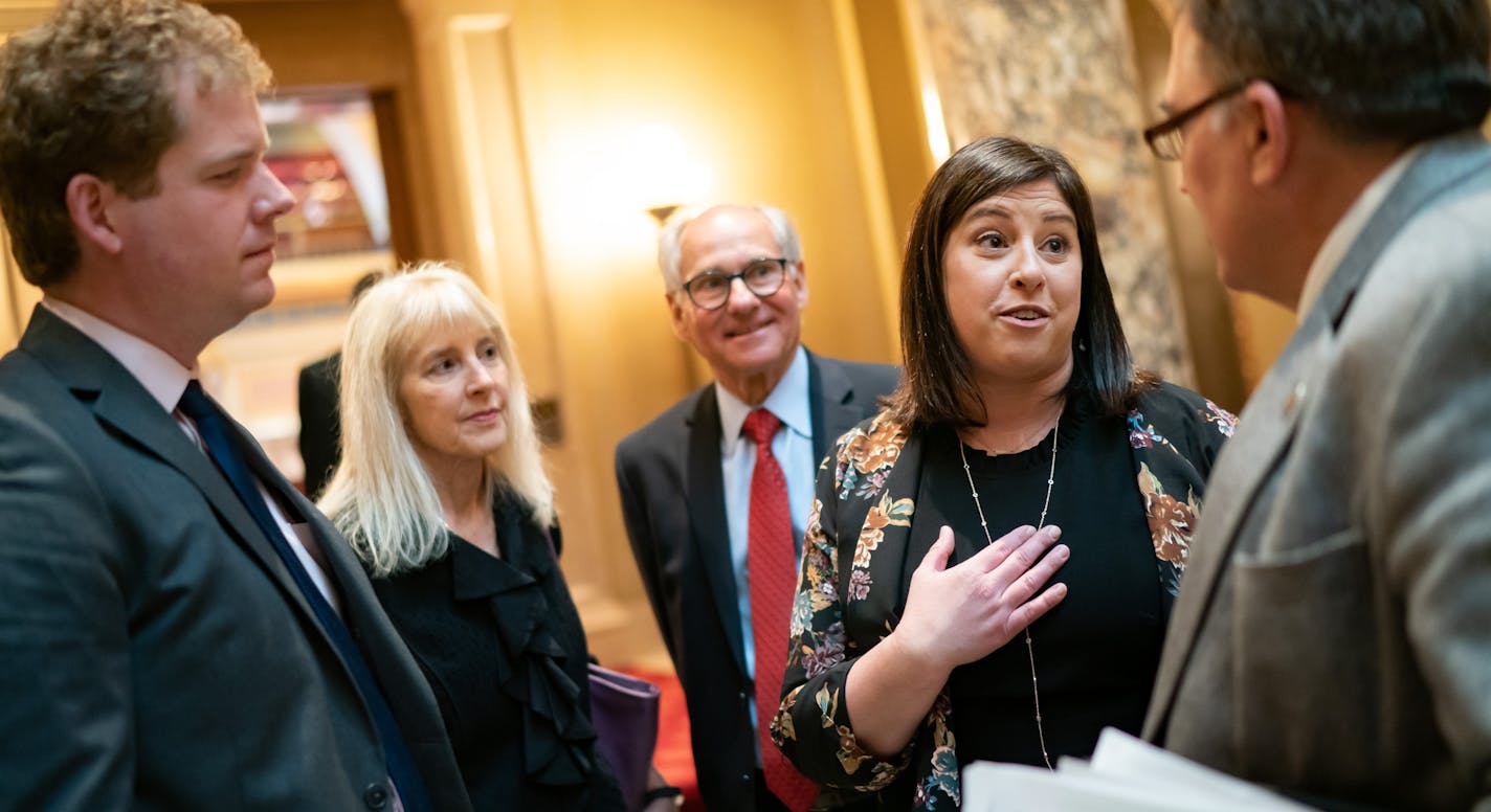 Jenny Teeson, who testified in front of various committees earlier this session about being drugged and raped by her ex-husband, thanked Sen. John Hoffman, D-Champlin, right and Rep. Zack Stephenson, D-Coon Rapids, left, outside the Senate where they voted on the bill Monday night.