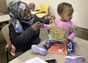 Foos Ahmed placed a special vest on her daughter Shaima Abdulle, 15-months. The vest holds a device that monitors the frequency of communication betwe
