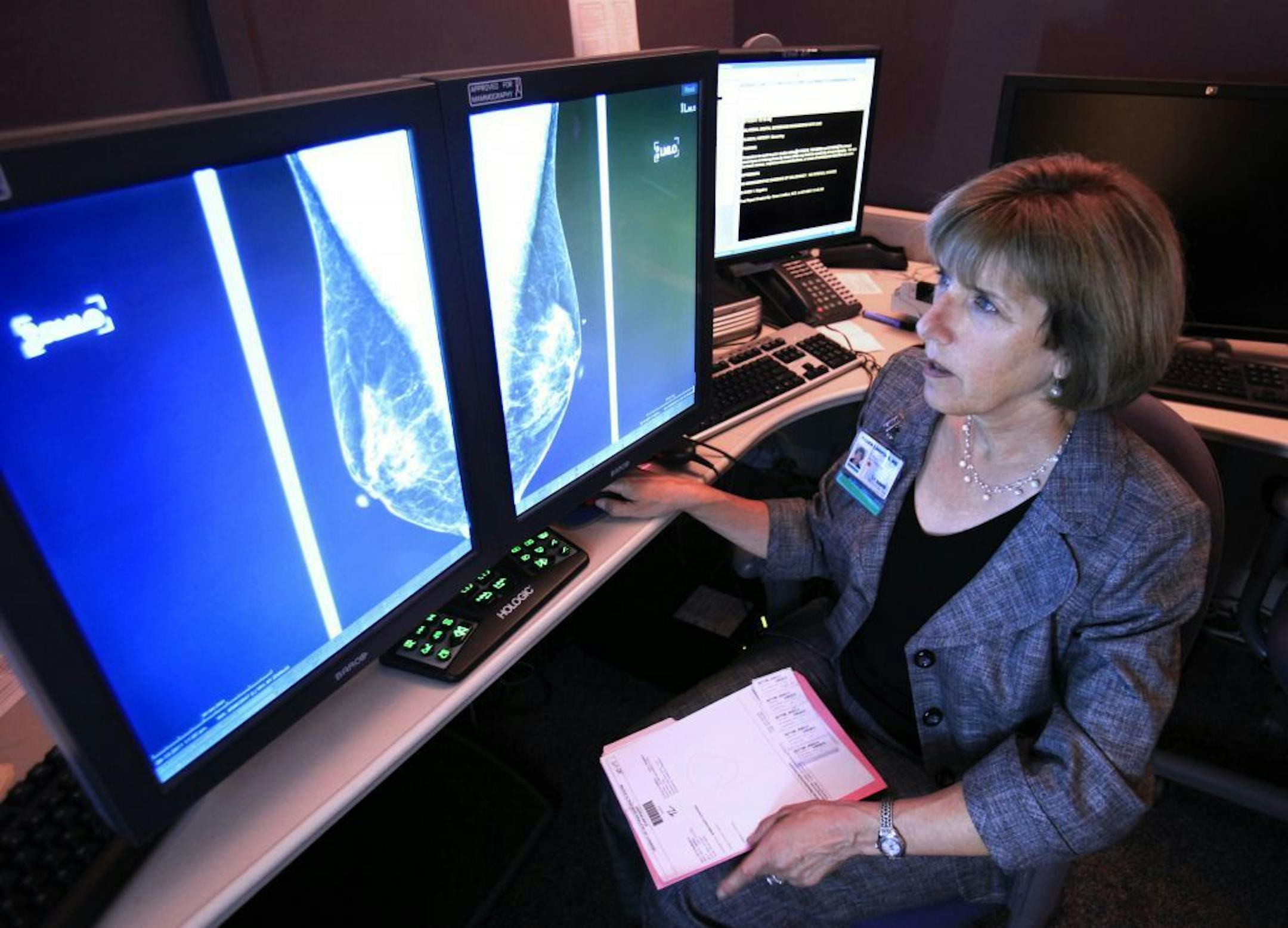 ln this photo taken Wednesday Sept. 14, 2011, Dr. Karen Lindsfor, a professor of radiology and chief of breast imaging at the University of California, Davis Medical Center, examines the mammogram of a patient with heterogeneously dense breast tissue, in Sacramento, Calif. Lindfors opposes a measure approved by the state Legislature earlier this month, that would require health facilities performing mammograms to notify patients with dense tissue that they may want to receive additional screenin