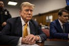 Former President Donald Trump sits in a courtroom next to his lawyer Todd Blanche, right, before the start of the day's proceedings in the Manhattan C