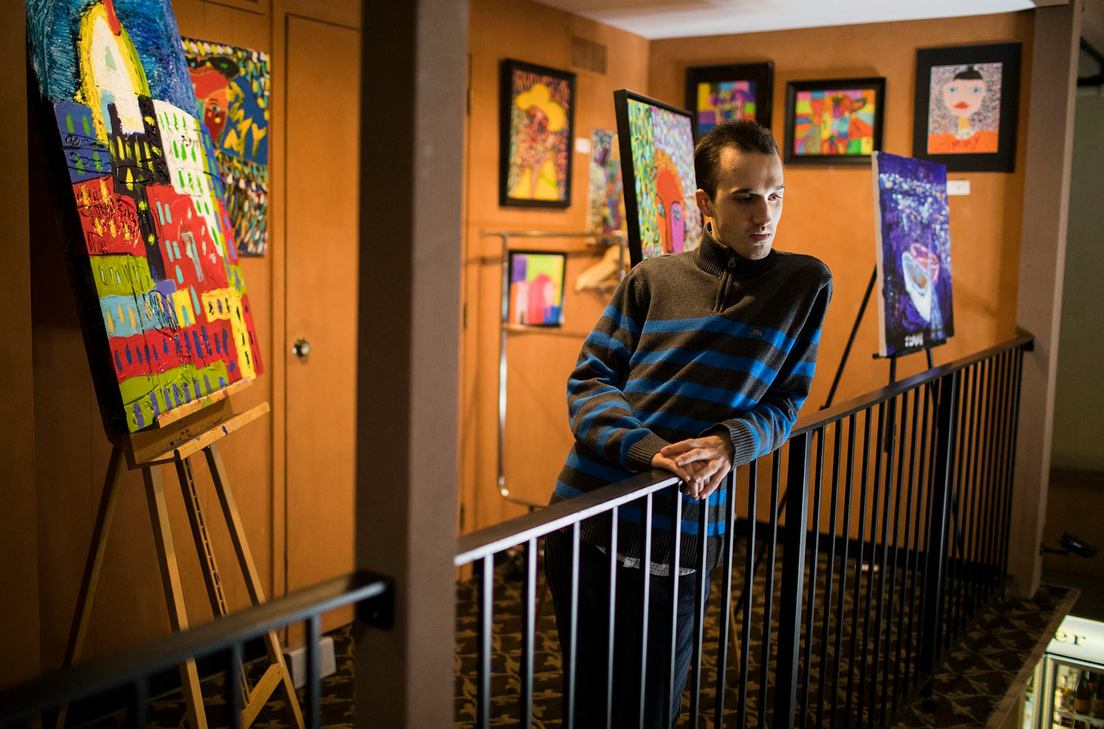 Jimmy Reagan poses with some of his artwork on display at Sunfish Cellars Wine & Spirits in St. Paul.
