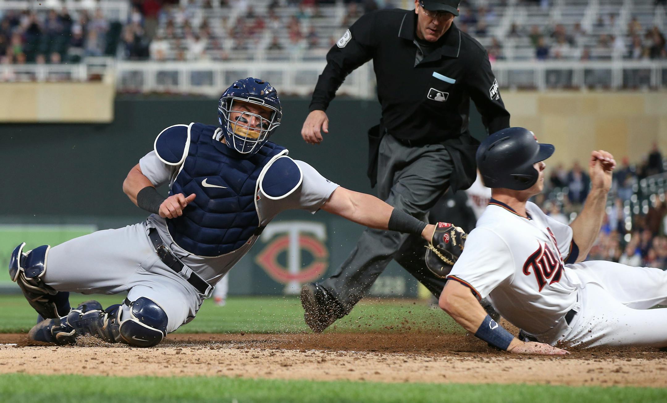 Minnesota Twins' Max Kepler, right, is tagged out by Detroit Tigers catcher James McCann as he tried to score on a single by Eduardo Escobar in the fifth inning of a baseball game Monday, May 21, 2018, in Minneapolis. (AP Photo/Jim Mone)
