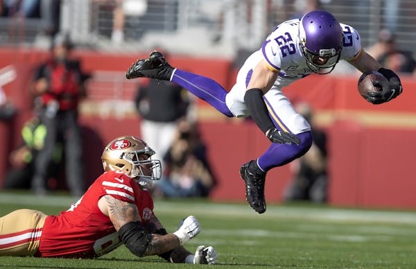 Minnesota Vikings safety Harrison Smith (22) jumps over San Francisco 49ers guard Daniel Brunskill (60) after intercepting a pass in the first quarter