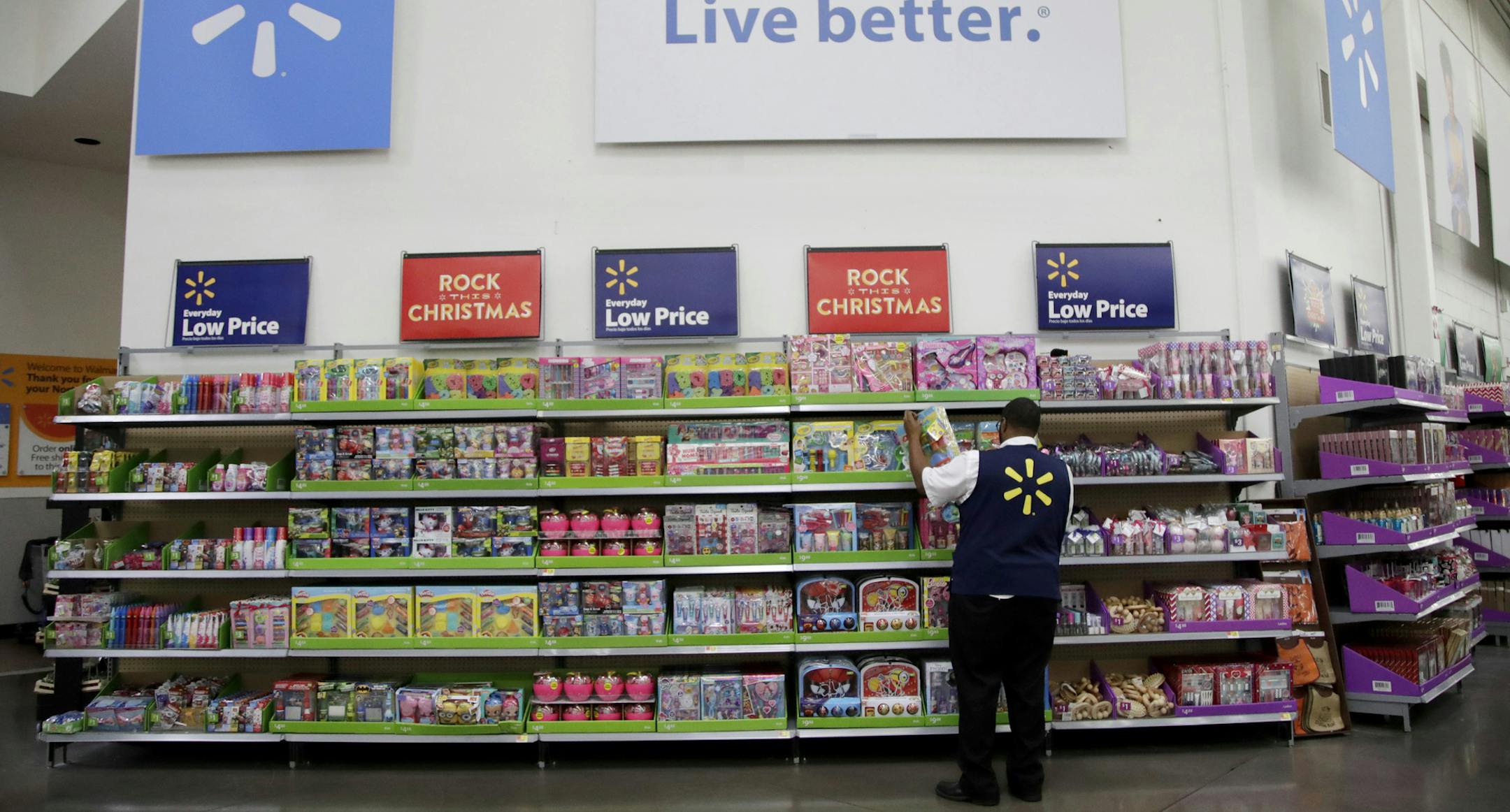 FILE- In this Nov. 9, 2017, file photo, Walmart employee Kenneth White scans items while conducting an exercise during a Walmart Academy class session at the store in North Bergen, N.J. Walmart reports financial results Tuesday, Feb. 20, 2018. (AP Photo/Julio Cortez, File)
