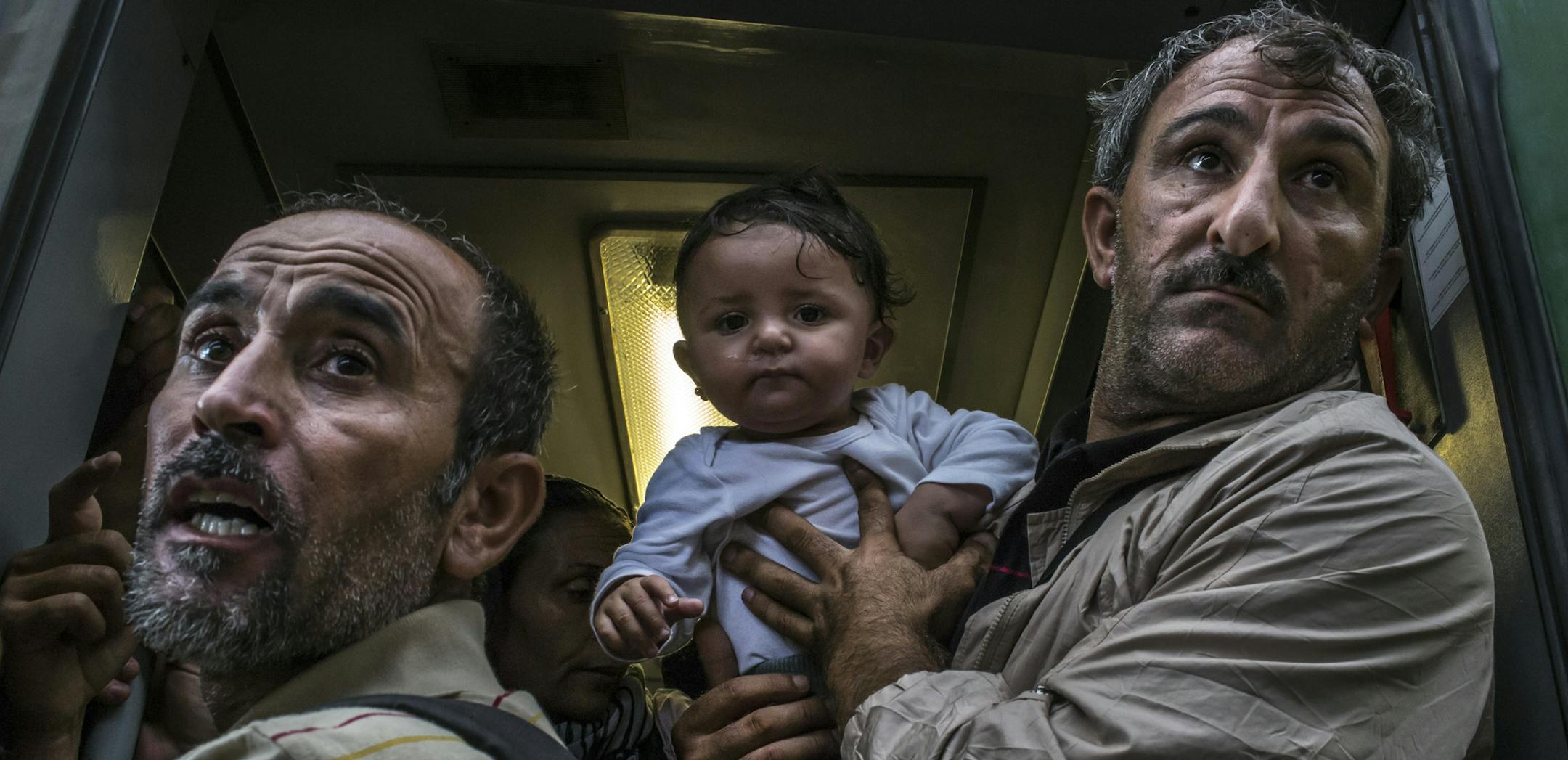 A migrant family boards a train amidst a crowd at Keleti station in Budapest, Sept. 3, 2015. Migrants poured into the station Thursday morning but were prevented from traveling to Germany as Hungaryís prime minister, Viktor Orban, said that the migration crisis was a ìGerman problemî and that Europe had a moral duty to tell migrants not to come. (Mauricio Lima/The New York Times)
