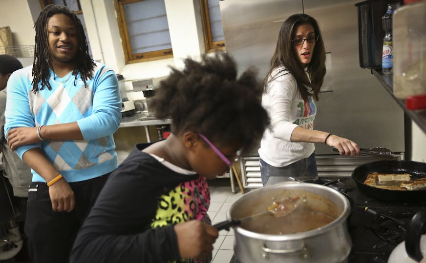 Michelle Horovitz (right), director of Appetite for Change, helped make egg rolls during a cooking workshop with teenagers at a church in Minneapolis, Minn., on Tuesday, September 17, 2013. A former public defender and lifelong foodie, Michelle Horovitz is taking an entrepreneurial approach to expanding Appetite for Change, the nonprofit she started in 2011 to help address the "food desert" in north Minneapolis. Also picture is Princess Ann Nelson (center) and De'Arreon Robinson (who works with