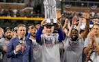 Texas Rangers manager Bruce Bochy holds up the trophy after Game 5 of the baseball World Series against the Arizona Diamondbacks Wednesday, Nov. 1, 20