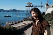 In this Dec. 1, 1969, file photo, John Trudell poses for a photo on steps leading to prison atop Alcatraz in San Francisco. After Trudell's death, Par