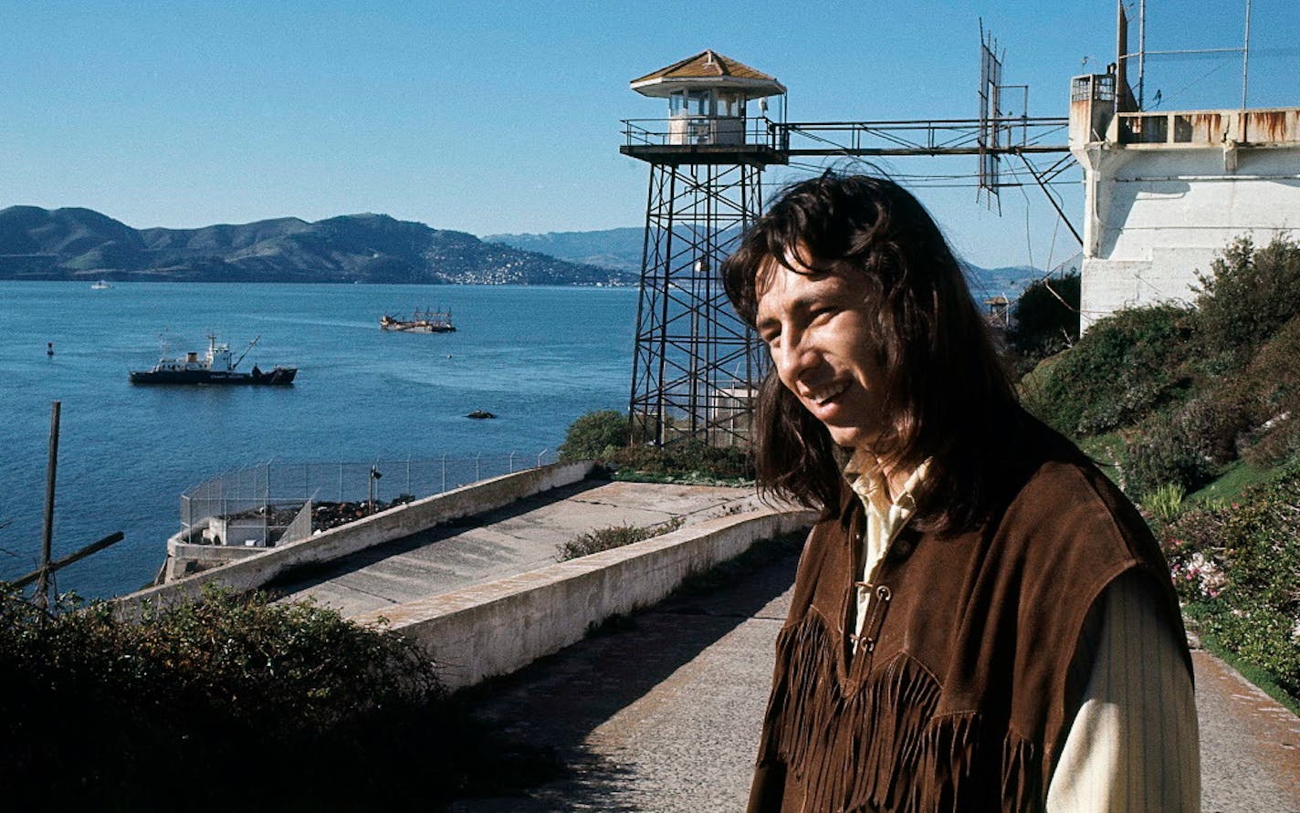 In this Dec. 1, 1969, file photo, John Trudell poses for a photo on steps leading to prison atop Alcatraz in San Francisco. After Trudell's death, Parker Higgins acquired a six-page dossier about Trudell from the FBI's Minneapolis office.