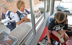 Ann Prigge picked up her sausage pizza as she joked around with Olivia Boxrud, 9, the cashier during lunch time. ] (KYNDELL HARKNESS/STAR TRIBUNE) kyn