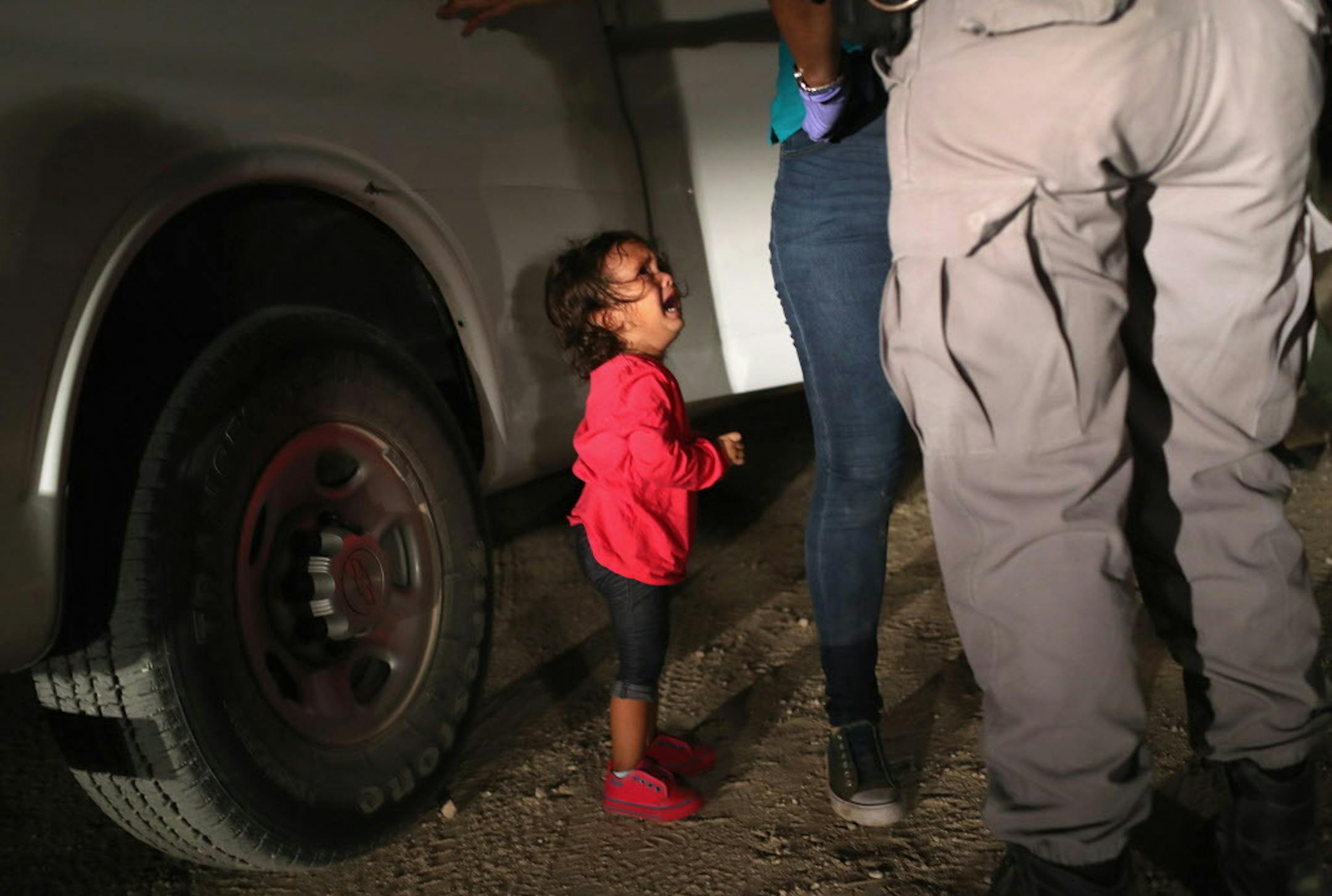 A 2-year-old Honduran asylum seeker cries as her mother is searched and detained near the U.S.-Mexico border on June 12, 2018, in McAllen, Texas. The asylum seekers had rafted across the Rio Grande from Mexico and were detained by U.S. Border Patrol agents before being sent to a processing center for possible separation. Customs and Border Protection (CBP) is executing the Trump administration's "zero tolerance" policy towards undocumented immigrants.