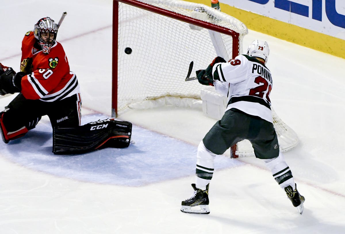 Chicago Blackhawks goalie Corey Crawford (50) looks on as Minnesota Wild right wing Jason Pominville (29) scores the game winning goal during the thir
