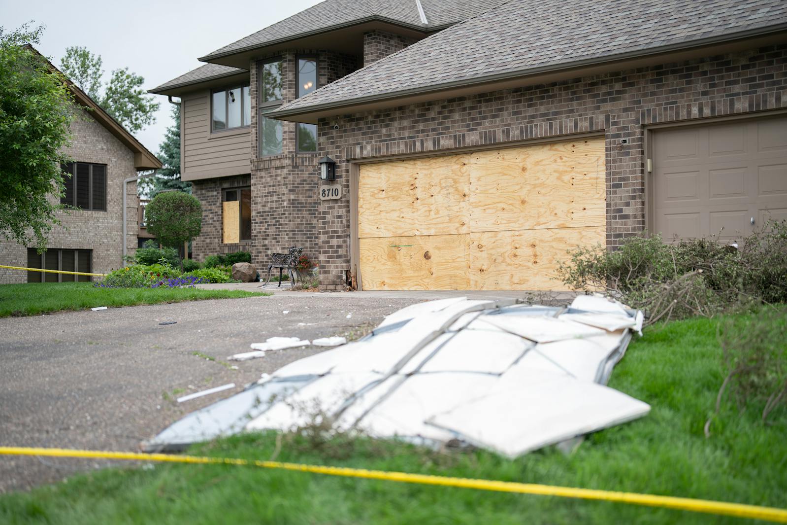 The exterior of DFL state Rep. Melissa Hortman’s home is boarded up and surrounded by police tape in Brooklyn Park on Sunday.