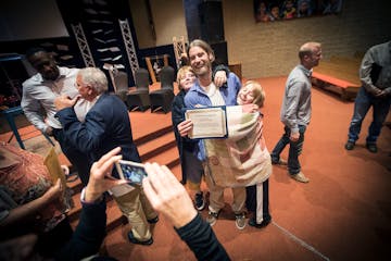 Alex Farchmin celebrated with his sons, Eian, 13, left, and Owen, 11, after he graduated from the Minnesota Adult & Teen Challenge treatment program i