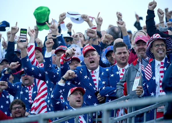 Fans, many keeping with the Ryder Cup tradition of over-the-top dress, celebrated at the first green at Hazeltine in Chaska. Many were up long before 