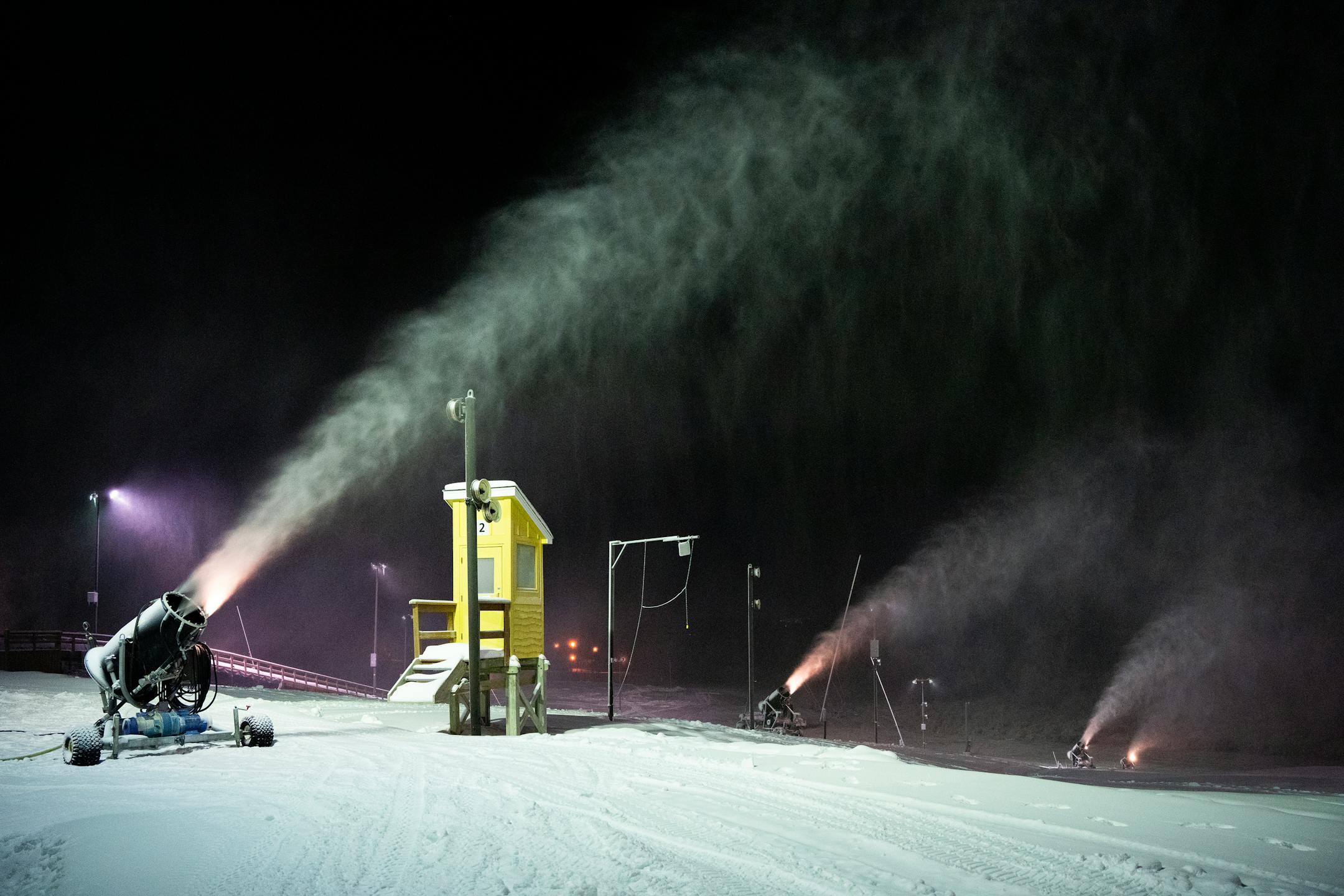 Snowmaking guns and skiers line the trails before the sun rises at the Elm Creek nordic ski area in Maple Grove , Minn., on Wednesday, Dec. 6, 2023. Elm Creek, part of Three Rivers Parks, makes snow from groundwater for cross country ski trails, tubing hill and snowboard park. ] SHARI L. GROSS • shari.gross@startribune.com