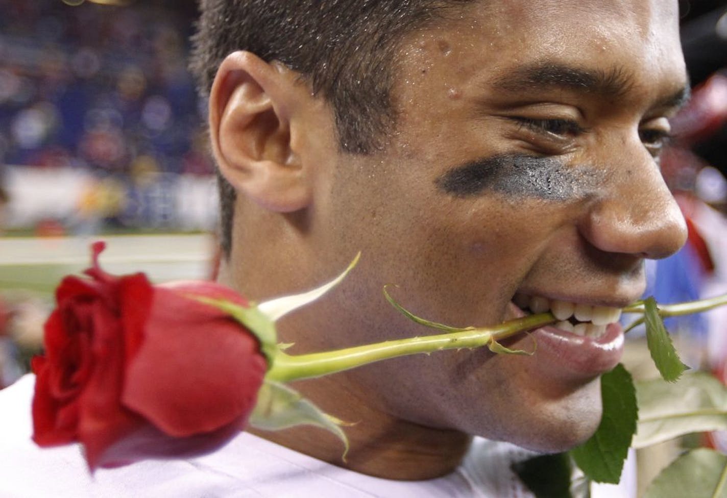 Wisconsin's Russell Wilson reacts after defeating Michigan State 42-39 in the Big Ten Conference championship NCAA college football game, Saturday, Dec. 3, 2011, in Indianapolis.