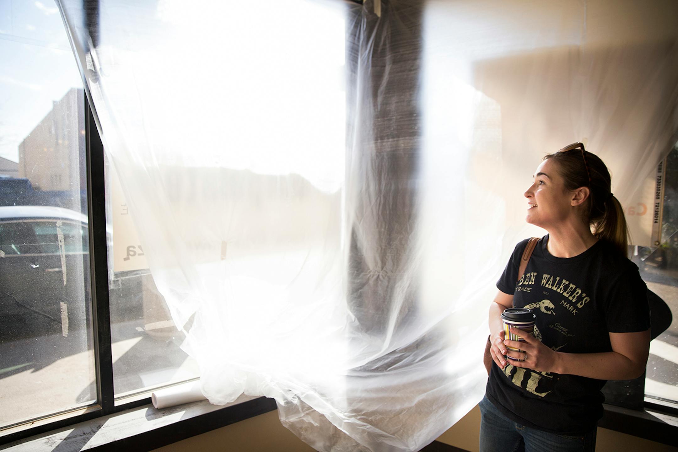 Kelsey Thorne, a trained chef who moved to Williston from Southern California with her husband, is planning on opening the first Italian restaurant in downtown Williston, North Dakota. Thorne peeks at her new window front restaurant space on Wednesday, April 1, 2015.
