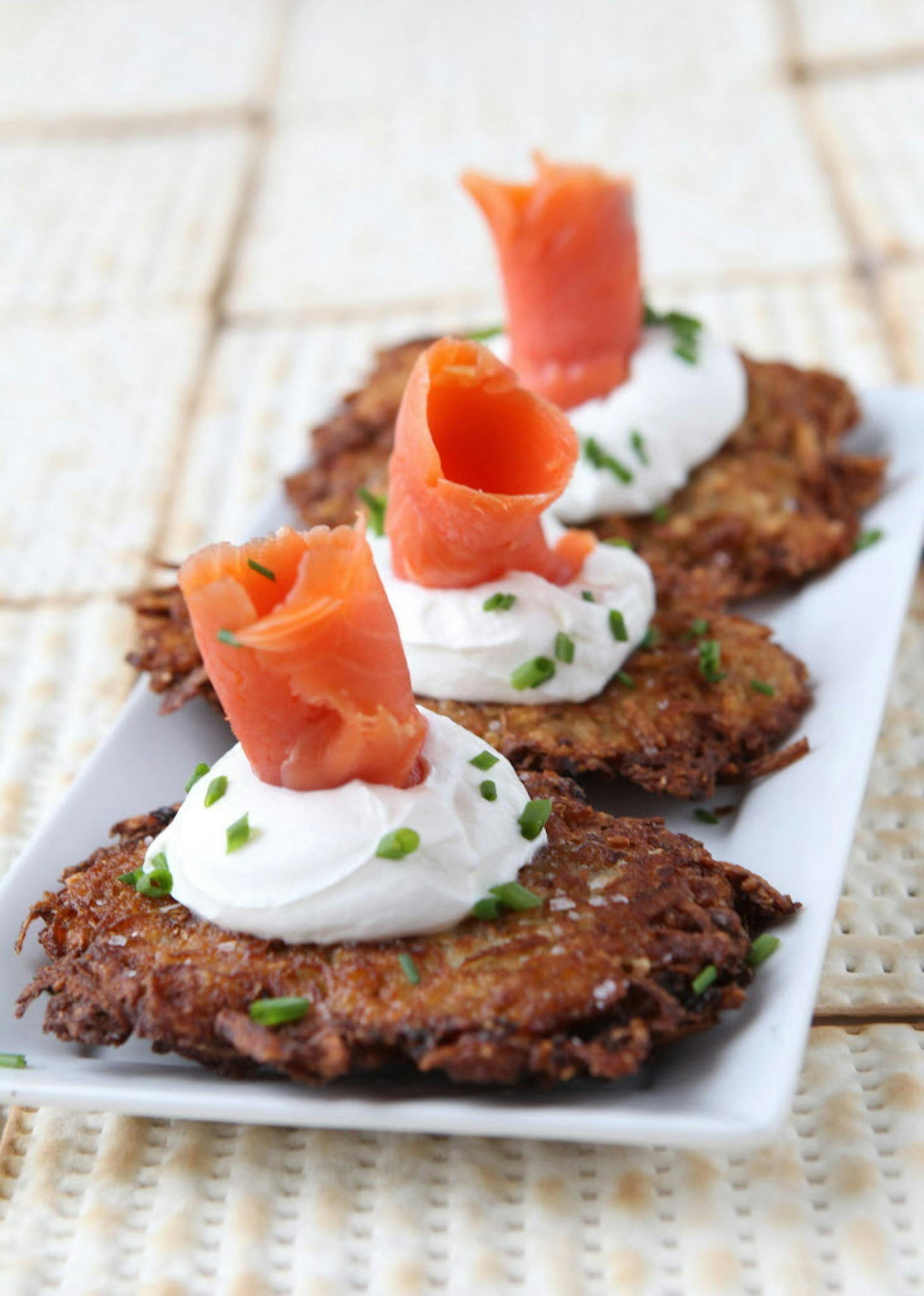 Passover latkes topped with sour cream, lox and chives. (Hillary Levin/St. Louis Post-Dispatch/TNS) ORG XMIT: 1183327