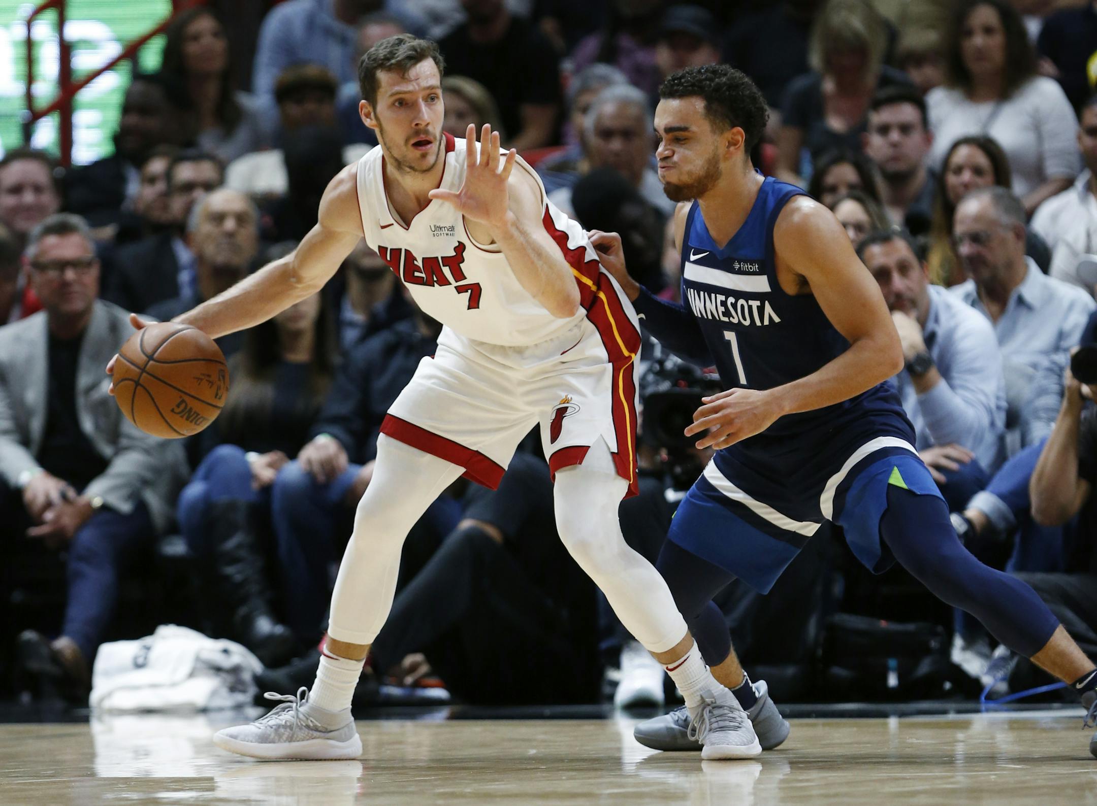 Miami Heat guard Goran Dragic, left, looks for an open teammate past Minnesota Timberwolves guard Tyus Jones, right, during the first half of an NBA basketball game, Monday, Oct. 30, 2017, in Miami. (AP Photo/Wilfredo Lee)