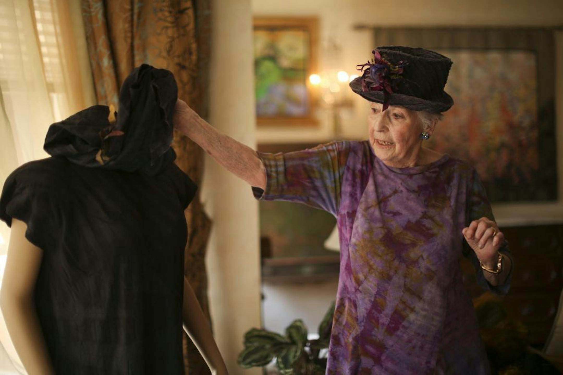 Gini Corrick is a textile artist who came to the craft late in life, but her wearable art has won national awards. She just turned 90 this month and the textile community is celebrating her work with her first one-woman show. Gini Corrick in her Minneapolis apartment Monday afternoon, May 6, 2013, wearing a dress that is among her latest work, as well as a hat that she made. She was discussing the finer points of a bias cut dress that she had made.