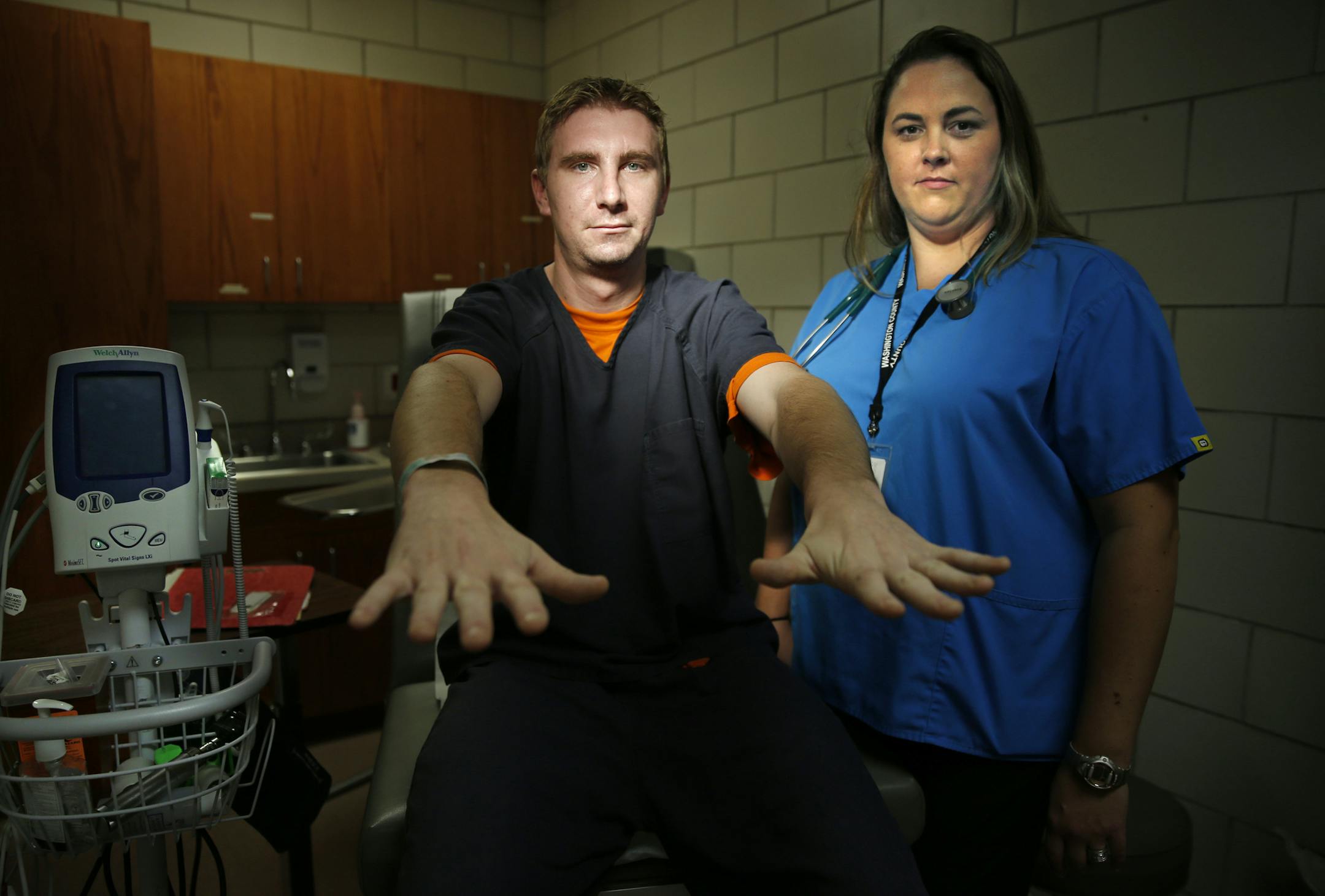 At the Washington County County Jail medical facility, prisoner Colin Riley is in jail for a probation violation. He is getting some meds to help through a detox process. He is showing how his hands shake through this process. Nurse Lindsey(last name whitheld) has been working in the department for about a year .]richard tsong-taatarii/rtsong-taataarii@startribune.com