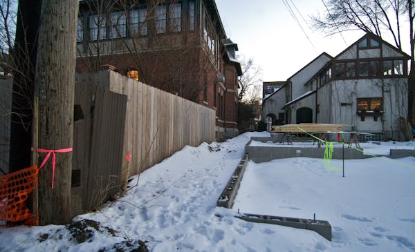 From the alley, Keillor's house is on the left. At right is Anderson's house, with some of the construction visible.
